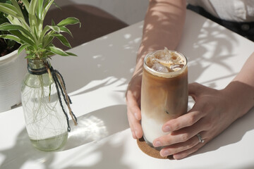 Hand holding iced milk tea
