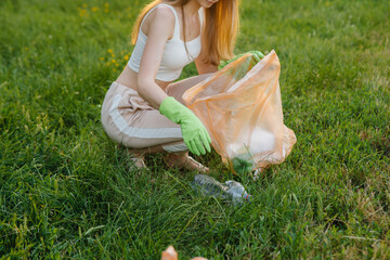A group of girls with children at sunset are engaged in garbage collection in the park....