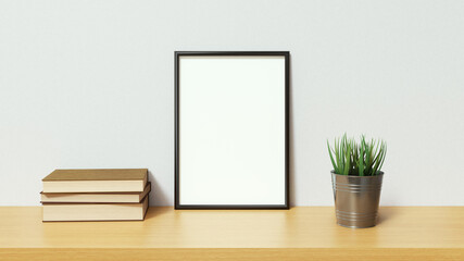 Blank picture with black frame on light wooden surface with books and plant. 3D Rendering