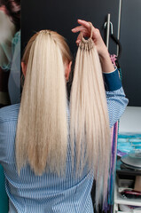 Blonde woman demonstrates fake ponytail - obrazy, fototapety, plakaty
