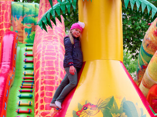Fototapeta na wymiar GOMEL, BELARUS - MAY 8, 2019: Children play on an inflatable slide attraction