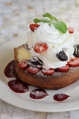 delicious dessert donuts with apples and ice cream on a white plate with decoration on a wooden table in a restaurant