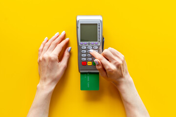 Hand swiping credit card by pos terminal. Payment transactions concept