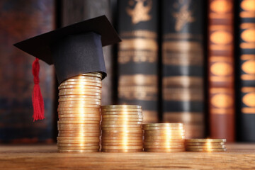Black Graduation cap over stack of coins
