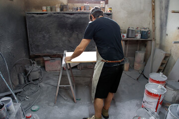 Carpenter varnishing a table