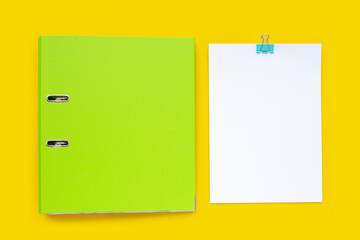 Office folder on yellow background. Top view