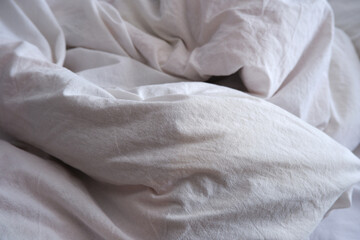 Bed linen texture. White bed linen background. Bed. Interior.