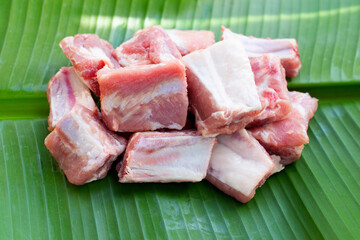 Raw pork ribs on banana leaf background