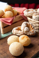 Brazil cheese bread and sweet biscuit on a table with green checkered tablecloth, selective focus.