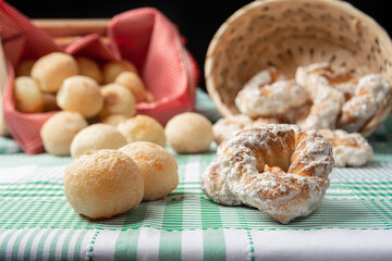 Brazil cheese bread and sweet biscuit on a table with green checkered tablecloth, selective focus.
