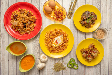 Typical dishes of popular Spanish gastronomy. Migas with fried egg, chickpea codido, fried artichokes with ham, Andalusian gazpacho, pork cheek, garlic and cardamom.