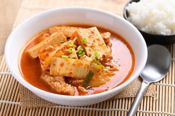 Kimchi soup with tofu and pork in a bowl eating with cooked rice, Korean food