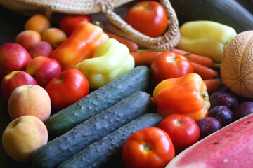 Straw bag and various seasonal fruit and vegetable. Selective focus.