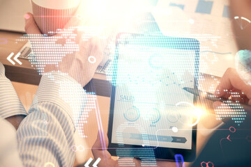 Multi exposure of man's hands holding and using a digital device and map drawing. International...
