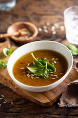 Homemade lentil soup with fresh spinach and seeds