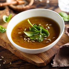 Homemade lentil soup with fresh spinach and seeds