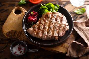 Grilled beef steak with fresh spinach