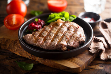 Grilled beef steak with fresh spinach