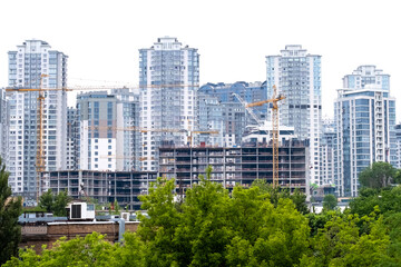 Fototapeta premium Cranes on a construction site of building of modern residential district