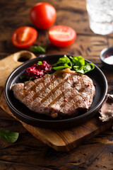 Grilled beef steak with fresh spinach