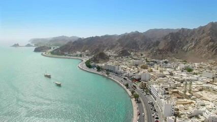 Muscat, Oman: Aerial view of capital city of sultanate on Arabian Peninsula, clear blue sky and emerald waters of Arabian Sea - landscape panorama of Middle East from above