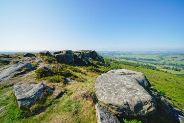 A hazy Derbyshire countryside on a bright summer morning from the top of Baslow Edge
