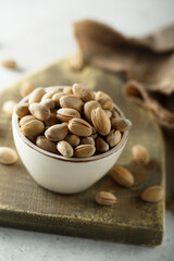 Salted pistachios in a white bowl