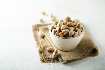Salted pistachios in a white bowl