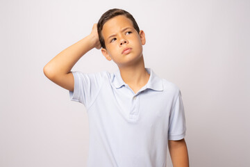 Beautiful child thinking and looking upward. Portrait of child on white background