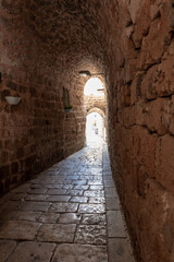 The tunnel  lined with stones passes under buildings in the old city of Acre in northern Israel