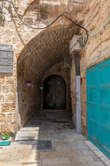 Fototapeta na wymiar The tunnel lined with stones passes under buildings in the old city of Acre in northern Israel