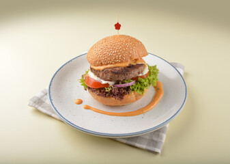 chef handmade grilled wagyu beef cheesy burger with French fries and sauce western halal menu