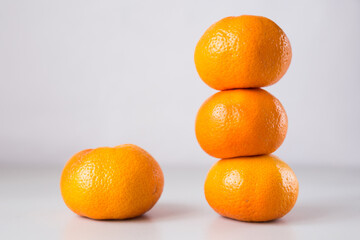 tower of three mandarines on white background
