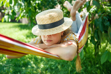 Summer vacation - lovely girl in a colorful hammock. High quality photo