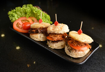 assorted mini burger canapés with meat and vegetable toast in party tray western bar halal menu