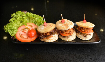 assorted mini burger canapés with meat and vegetable toast in party tray western bar halal menu