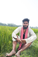 Indian Young Rural Farmer  Sitting in agricultural field