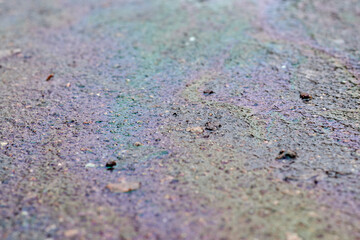 Oil spot on the ground, colored texture and pattern of gasoline.