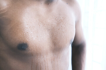 young man skin sweating in chests .