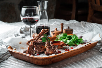 Grilled lamb loin on a wooden plate with wine