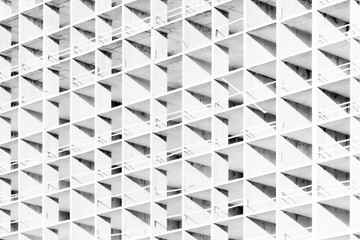 The light or bright black and white background or backdrop of new concrete building construction in the rays of midday sun with many lines, squares, rhombs,triangles and rectangles