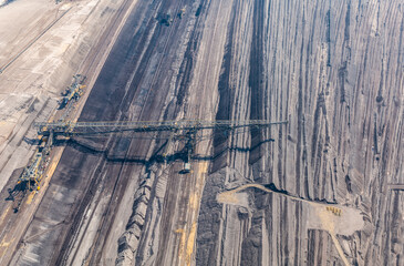 Aerial view of an open pit mine in Germany with brown coal digging by giant excavators 