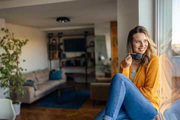 Adult woman, waiting for her tea to cool down.