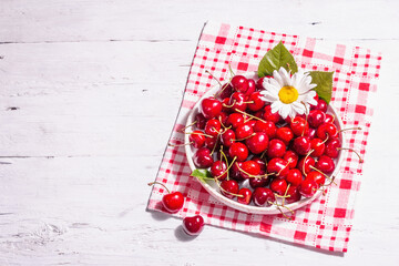 Fresh ripe sweet cherries in a bowl with droplets of water