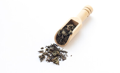 Dry green tea with scoop isolated background