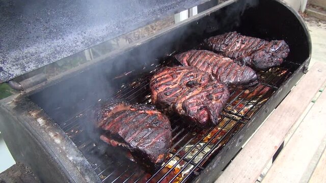 Pork Boston Butts Being Smoked On A Barbeque Grill 