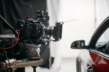 Professional cinema and video camera on the set. Shooting shift, lighting fixtures, shooting equipment and the team.