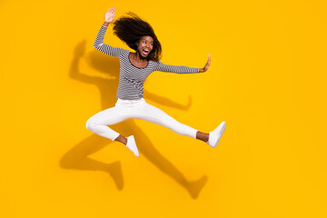 Fototapeta na wymiar Full length body size photo woman in white pants practicing karate kicking with leg isolated vibrant yellow color background