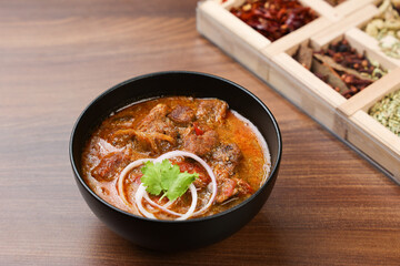 Traditional homemade Mutton curry from Asian cuisine. Chukhandar gosht. Spicy delicious meat beef curry. Bowl of tasty mutton roast Indian spices. side dish of Ghee rice, Appam, Parotta, Puttu