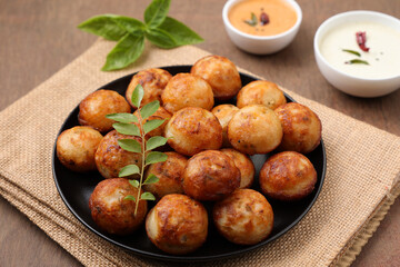 Paniyaram, Kuzhi paniyaram Gunta ponganalu paddu, guliyappa made of black lentils and rice deep fried snack or breakfast vegan vegetarian South Indian Kerala Tamil Nadu Karnataka Sri Lanka Lankan food
